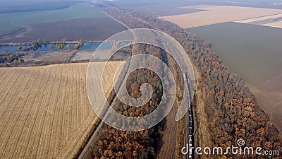 Panoramic Moving Freight Train Along Railway Tracks, Trees Agricultural Fields Stock Photo