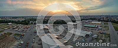 Panoramic overview over the popular Oktoberfest under construction at the late evening sunset. Editorial Stock Photo