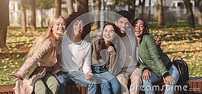 Panoramic photo of joyful multiracial teenagers resting in park Stock Photo