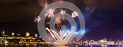 Panoramic photo: Small fireworks over a big river Stock Photo