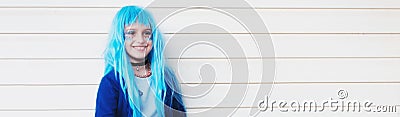 Panoramic portrait of happy teenage girl with blue hair, on background of white wall with lines. Stock Photo