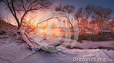 Panoramic russian winter landscape with forest, beautiful frozen river at sunset. Scenery with winter trees, water and blue sky Stock Photo