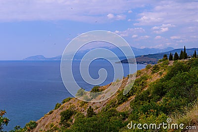 Panoramic sea and rocky mountains from the height of another hill. Place for extreme active rest Stock Photo