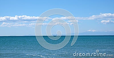 Panoramic seascape with sea surface and high mountains silhouettes Stock Photo