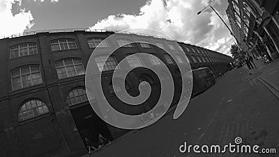 Panoramic shot of an abstract grayscale of a street with modern buildings and a bus Stock Photo