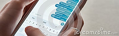 Panoramic shot of abuser sending offensive messages while using smartphone, illustrative editorial. Stock Photo
