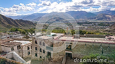 Panoramic shot of the city of Lhasa stretching towards the rocky Himalaya. Stock Photo