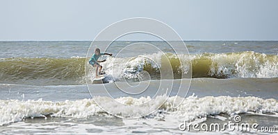 Panoramic shot of talented kid surfing waves on the Atlantic Ocean Stock Photo
