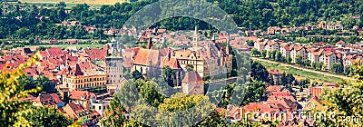 Panoramic summer cityscape of Sighisoara with Clock Tower and City Hall. Bright afternoon view of medieval town of Transylvania, R Stock Photo