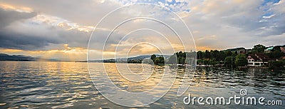 Panoramic summer view of boat cruise excursion landscape on Zurichsee with beautiful sunset shining light through clouds reflected Stock Photo