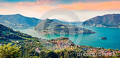 Panoramic summer view of Iseo lake. Impressive sunrise on Marone town with Monte Isola island, Province of Brescia, Italy, Europe. Stock Photo