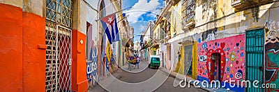 Urban scene with a cuban flag on a colorful street in Havana Editorial Stock Photo