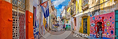 Urban scene with a cuban flag on a colorful street in Havana Editorial Stock Photo