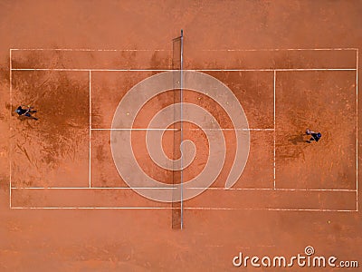 A panoramic view from above captures a tennis training session. The players on the court are focused, showcasing skill Stock Photo