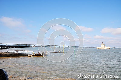 Panoramic view of the Bay of Biscay. Boat of oyster farm workers. View of the great bridge on the Ile d`Oleron. Editorial Stock Photo