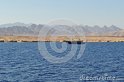 Panoramic view of the bay. A ship with masts is sailing along the bay. Stock Photo