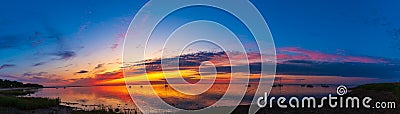 Panoramic view of a beautiful sunset sky over the sea with boats in Loissin bei Greifswald Stock Photo