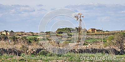 Panoramic view on a beautiful wild west landscape with stone walls, cottage and a broken windmill in Dingli, Malta on a sunny, Stock Photo