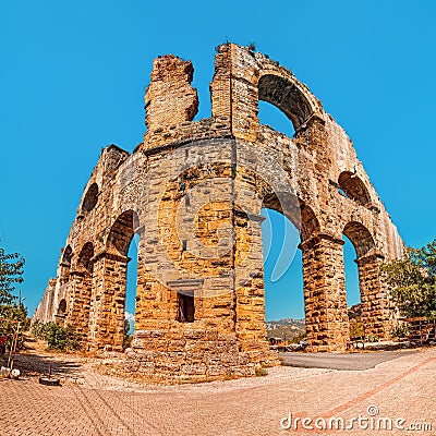 View from below of the ancient Roman or Lycian aqueduct for the water supply of Aspendos city situated on a hill in Stock Photo