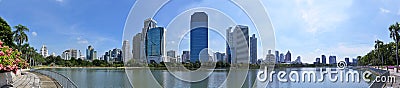 Panorama of Benjakitti Park from west end of Lake Ratchada with view of commercial buildings along Ratchadaphisek Road, Bangkok Editorial Stock Photo