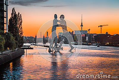 Berlin skyline with Molecule Man sculpture in Spree river at sunset, Germany Editorial Stock Photo