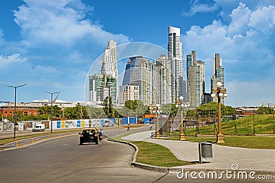 Panoramic view of car driving towards the skyline of Buenos Aires, against a blue summer sky with few white clouds. Editorial Stock Photo