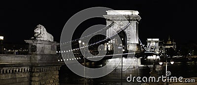 Panoramic view of the Chain Bridge at night in Budapest with the lions in the foreground, Hungary Editorial Stock Photo