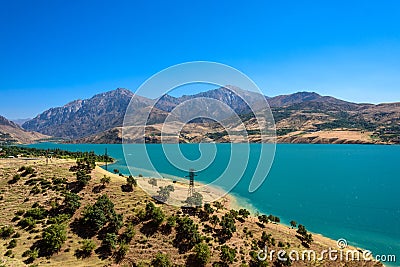 Panoramic view of Charvak Lake, a huge artificial lake-reservoir created by erecting a high stone dam on the Chirchiq River Stock Photo