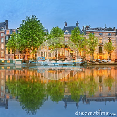 Panoramic view and cityscape of Amsterdam with boats, old buildings and Amstel river, Holland, Netherlands Stock Photo