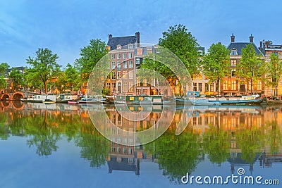 Panoramic view and cityscape of Amsterdam with boats, old buildings and Amstel river, Holland, Netherlands Stock Photo
