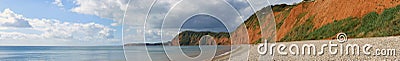 A Panoramic view of the cliffs at Sidmouth in Devon, showing the stone shore and the oxidised cliffs in the bay Stock Photo