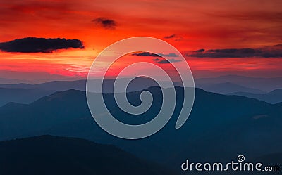 Panoramic view of colorful sunset in the mountains. Dramatic overcast sky. Stock Photo