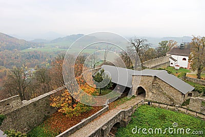 Panoramic view of courtyard of Hukvaldy medieval castle with colorful autumn forest and mountains on the background Stock Photo