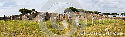 Panoramic view in 180 degrees in the Roman empire village ruins in Ostia Antica with the gym of Neptune spa at archaeological Stock Photo