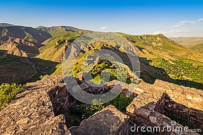 View of the famous Smbataberd fortress in the Armenian Transcaucasia with gorgeous views of mountain valleys at golden Stock Photo