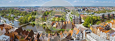 Panoramic view of the Holsten Gate in Luebeck, old bricks building and river. Aerial view Editorial Stock Photo