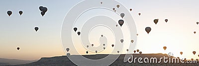 Panoramic view landscape with hot air balloons, sunrise and mountains on background Stock Photo