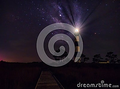 Panoramic view of Lighthouse and Milky Way galaxy at night Stock Photo