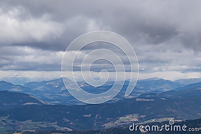 Panoramic view of Lower Tauern (Niedere Tauern) and Seckauer Alps seen from Saualpe, Lavanttal Alps. Rain storm incoming Stock Photo