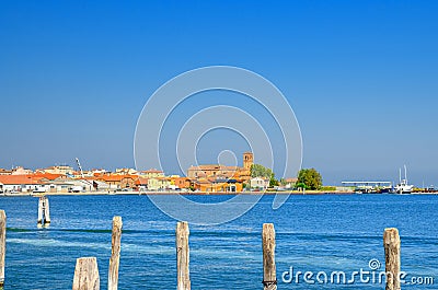 Panoramic view of Lusenzo lagoon with wooden poles in water and Chioggia town Stock Photo