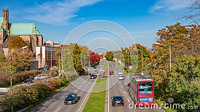Panoramic view of Maria Magdalena Chapel, Saint Petri Church and Evangelical Church at Autumn near highway with cars in Magdeburg Editorial Stock Photo