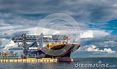 Merchant Cargo Container vessel berthed with cloudy backdrop Editorial Stock Photo