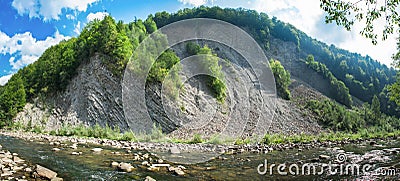 Panoramic view on mountain river in front of mountain range Stock Photo