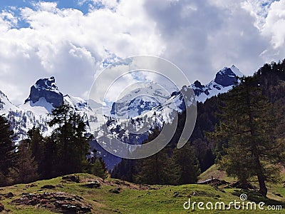 Panoramic view of mountaintops against cloudy sky Stock Photo