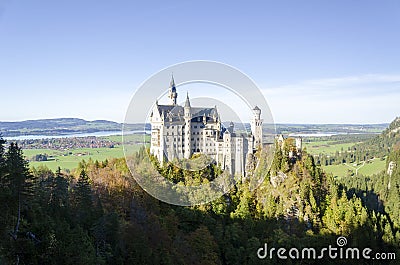 A panoramic view of Neuschwanstein Castle with trees in Bavaria Germany. Stock Photo