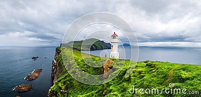 Panoramic view of old lighthouse on the Mykines island Stock Photo