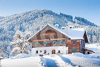 Traditional farmhouse in winter wonderland in the Alps Stock Photo