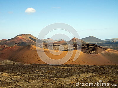 Panoramic view over lava field on crater and cone of red volcanoes in Timanfaya NP, Lanzarote, Canary Islands Stock Photo