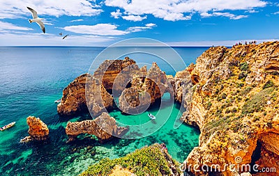 Panoramic view, Ponta da Piedade with seagulls flying over rocks near Lagos in Algarve, Portugal. Cliff rocks, seagulls and Stock Photo