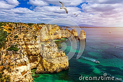 Panoramic view, Ponta da Piedade with seagulls flying over rocks near Lagos in Algarve, Portugal. Cliff rocks, seagulls and Stock Photo